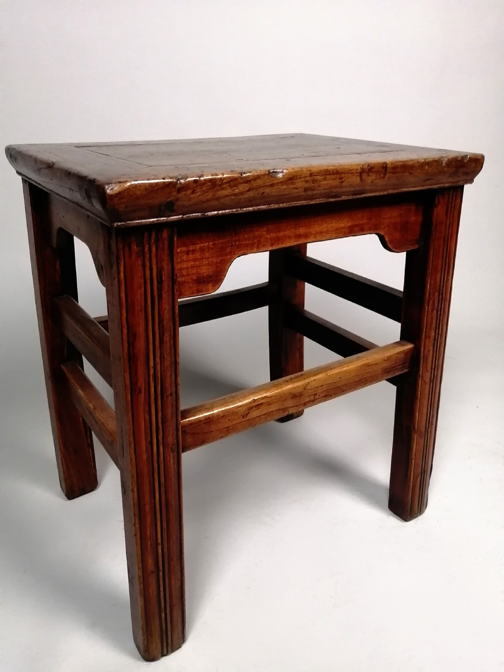 An 18th-century Chinese elm side table featuring a rectangular framed top, shaped apron spandrels, fluted legs, and double stretchers. View III