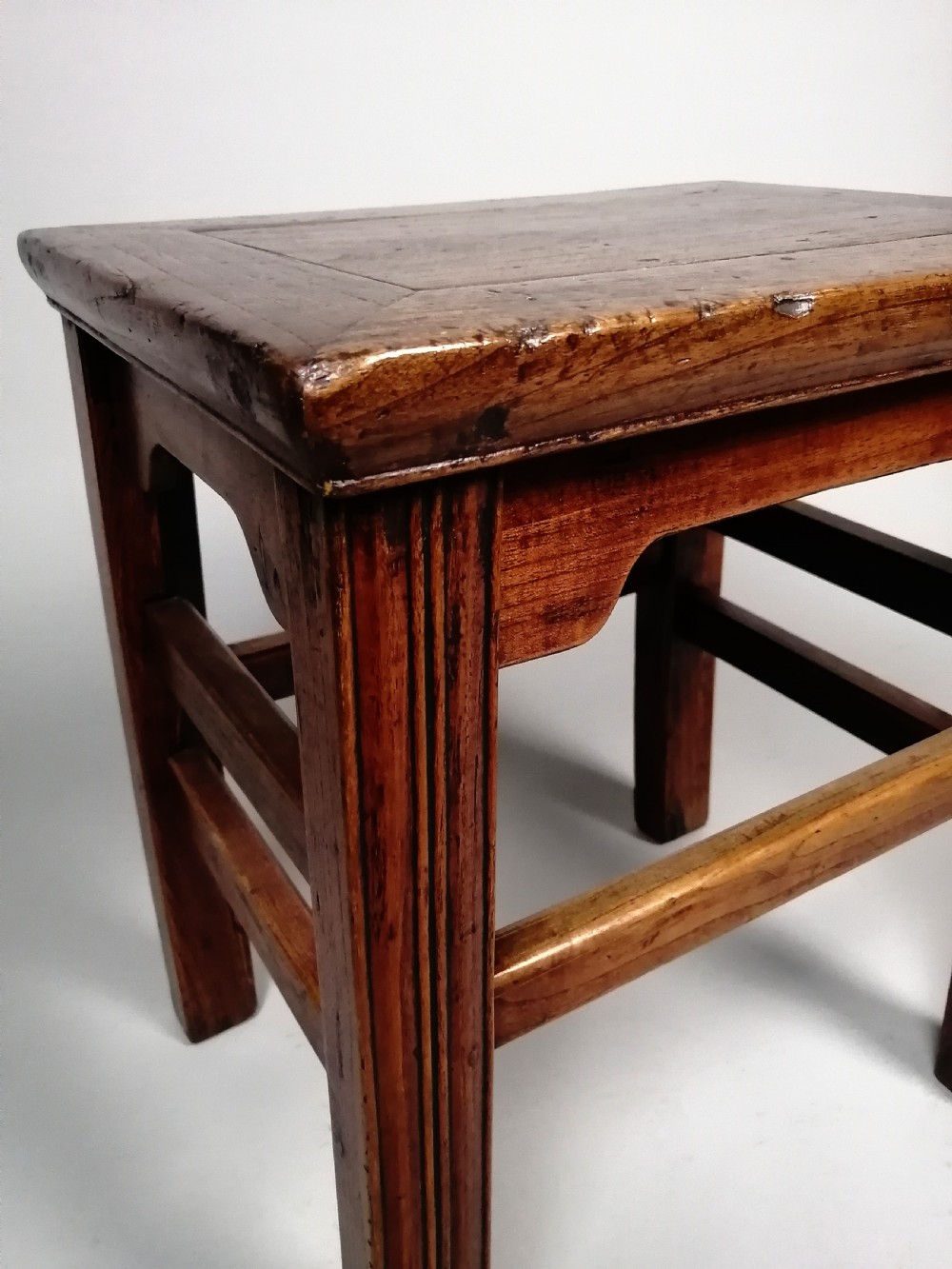 An 18th-century Chinese elm side table featuring a rectangular framed top, shaped apron spandrels, fluted legs, and double stretchers. View IV