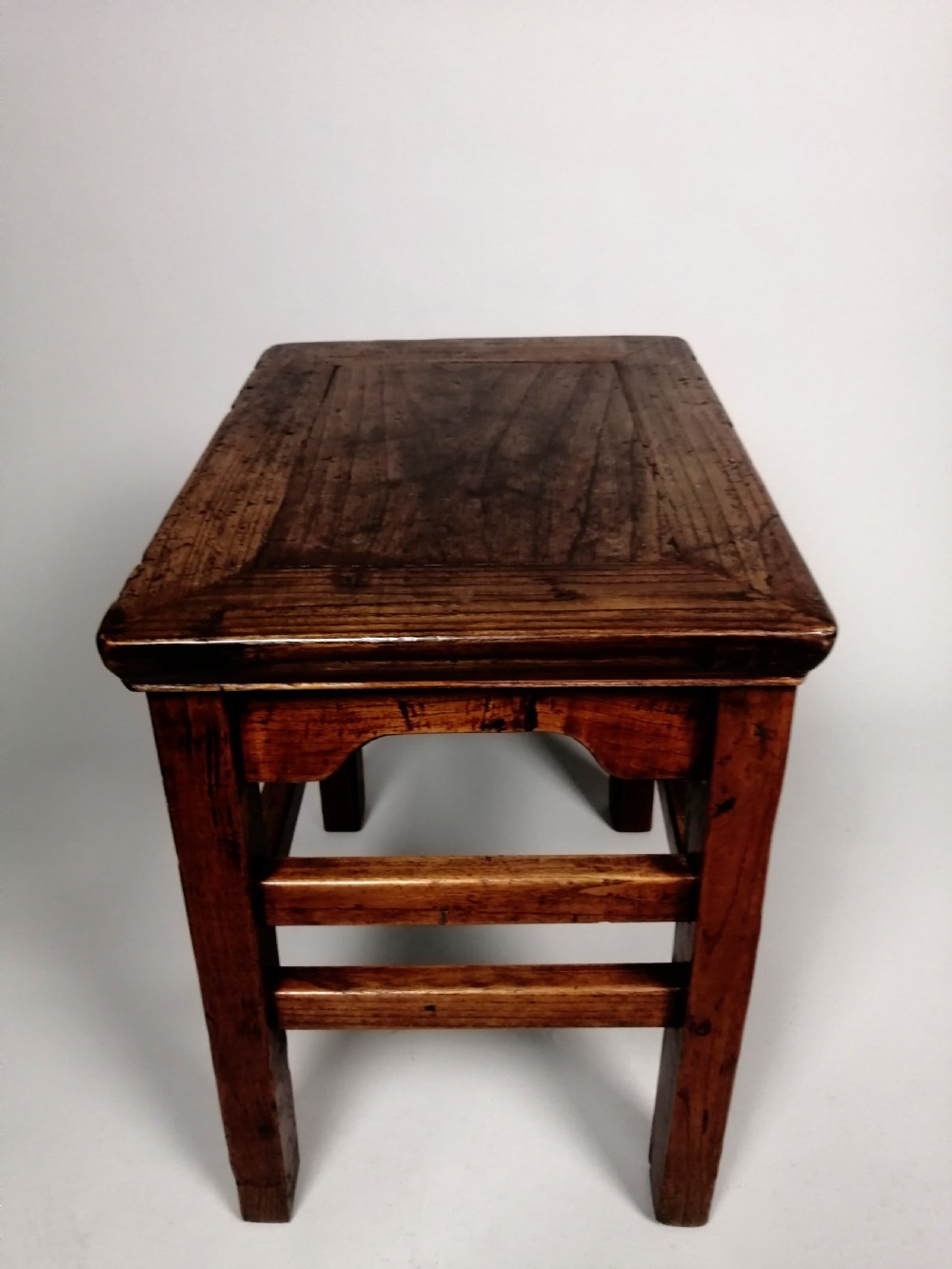 An 18th-century Chinese elm side table featuring a rectangular framed top, shaped apron spandrels, fluted legs, and double stretchers. View VIII