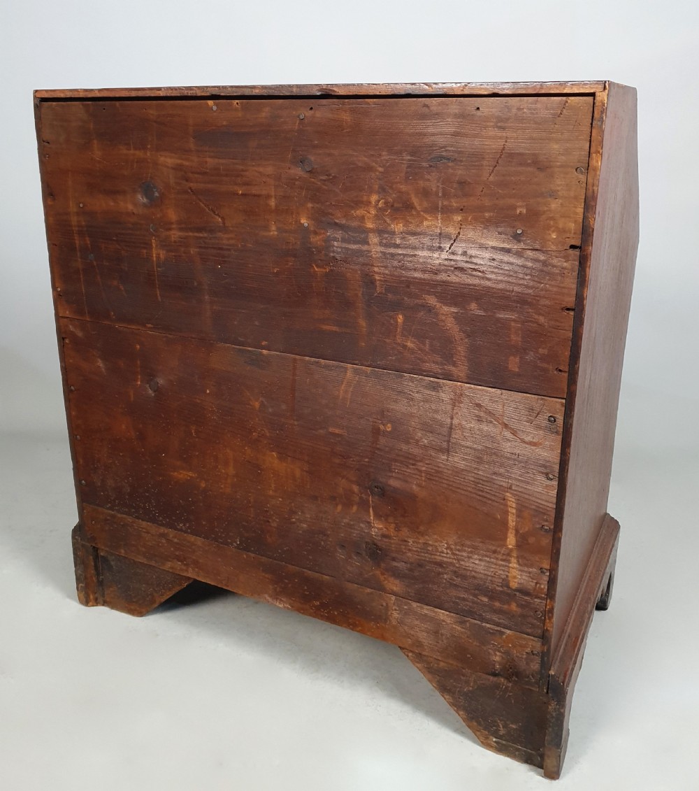 An 18th-century George II slant-front writing bureau made of warm brown fruitwood with brass drop handles and bracket feet. View VI