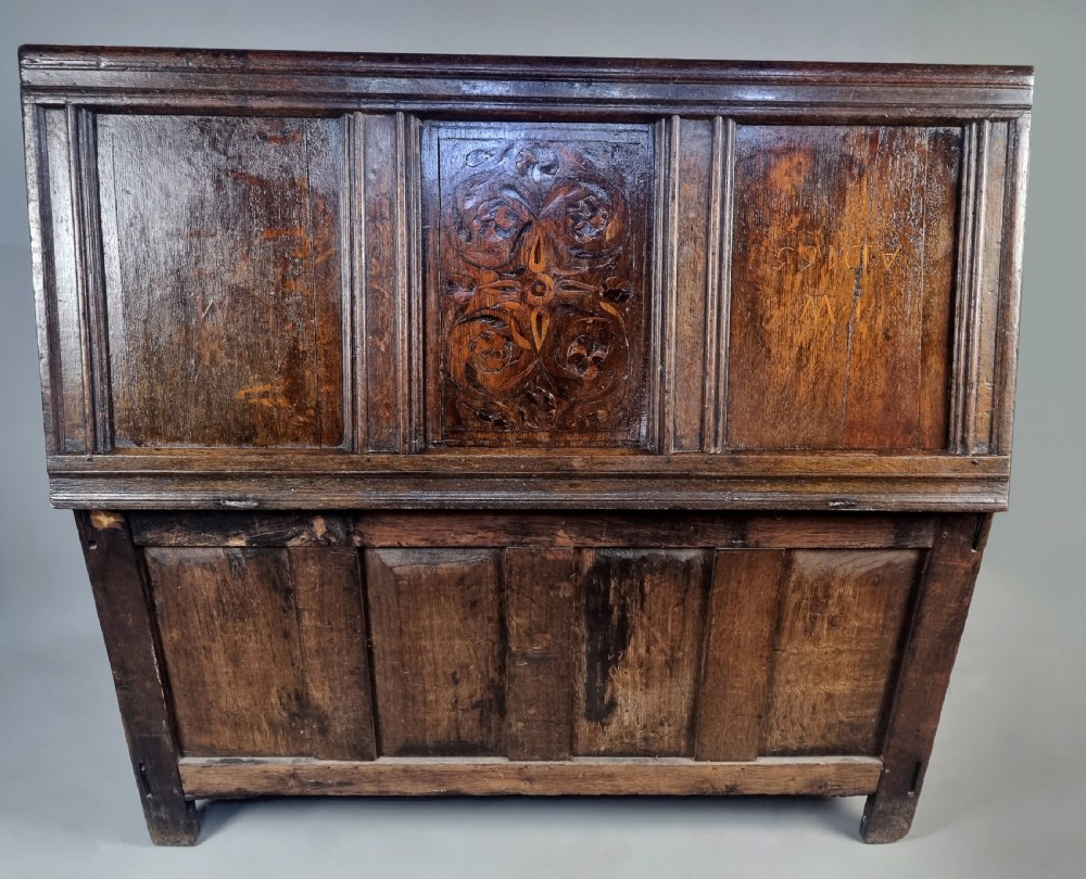 A 17th-century dark oak coffer featuring four front panels with floral marquetry inlay and a panelled hinged top. View IX