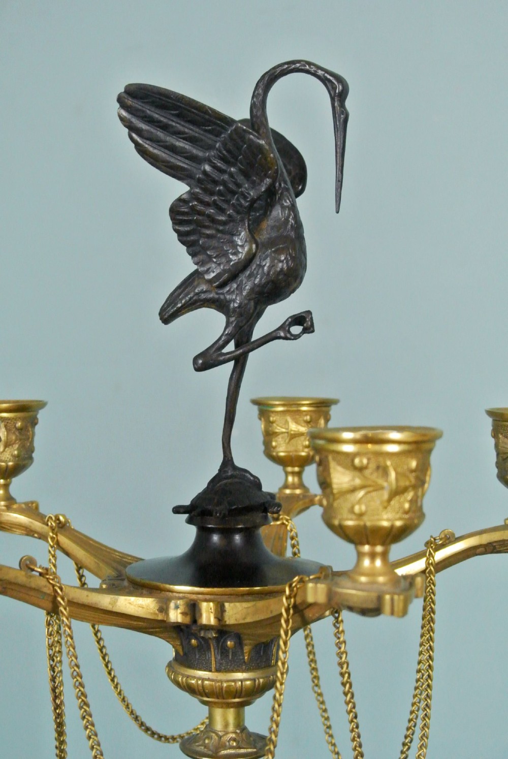 A pair of late nineteenth-century French ormolu and patinated bronze multi-light candelabra topped with crane figures and hung with small gilt chains. View VII