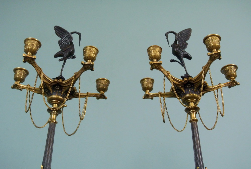 A pair of late nineteenth-century French ormolu and patinated bronze multi-light candelabra topped with crane figures and hung with small gilt chains. View XI