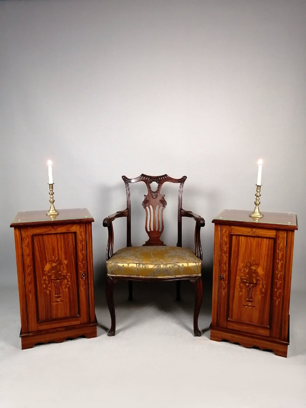 A matching pair of late 19th-century rosewood bedside cabinets featuring detailed floral marquetry inlays on the central door panels. View IX