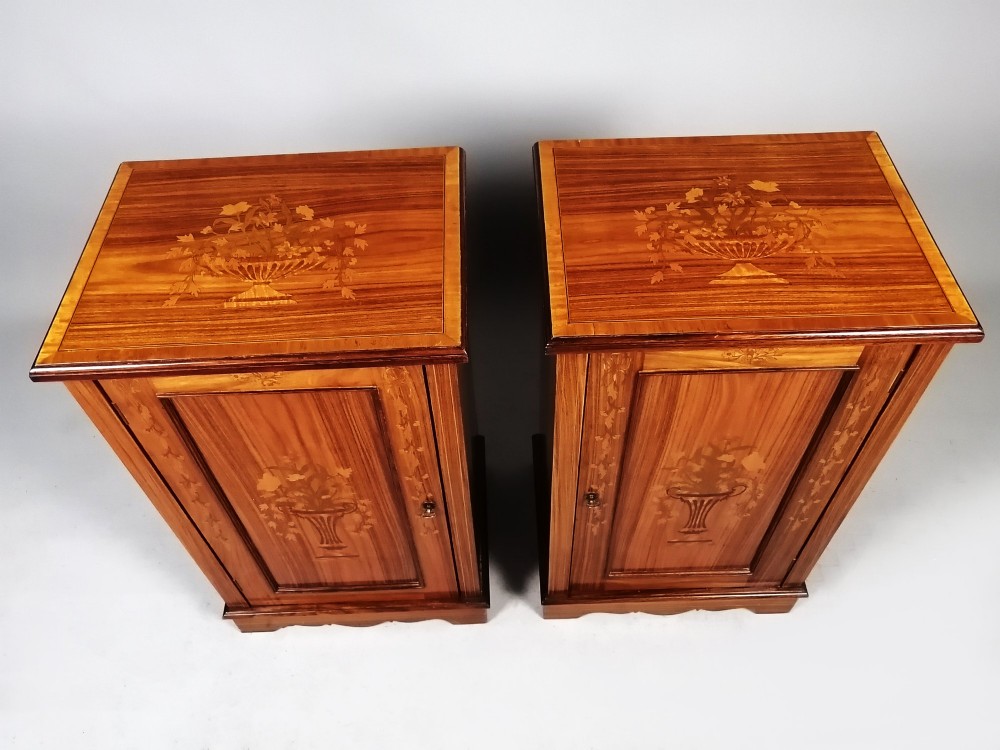 A matching pair of late 19th-century rosewood bedside cabinets featuring detailed floral marquetry inlays on the central door panels. View X