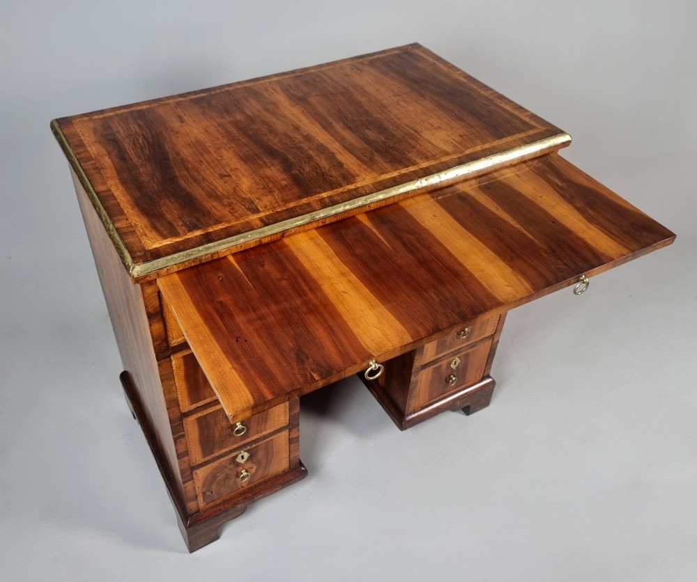 An 18th-century George II yew wood kneehole dressing table with multiple drawers, brass drop handles, and a central recessed cupboard. View VI