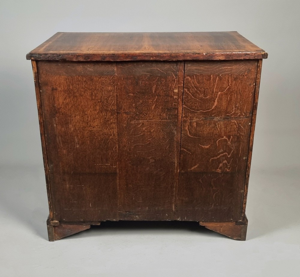 An 18th-century George II yew wood kneehole dressing table with multiple drawers, brass drop handles, and a central recessed cupboard. View VII