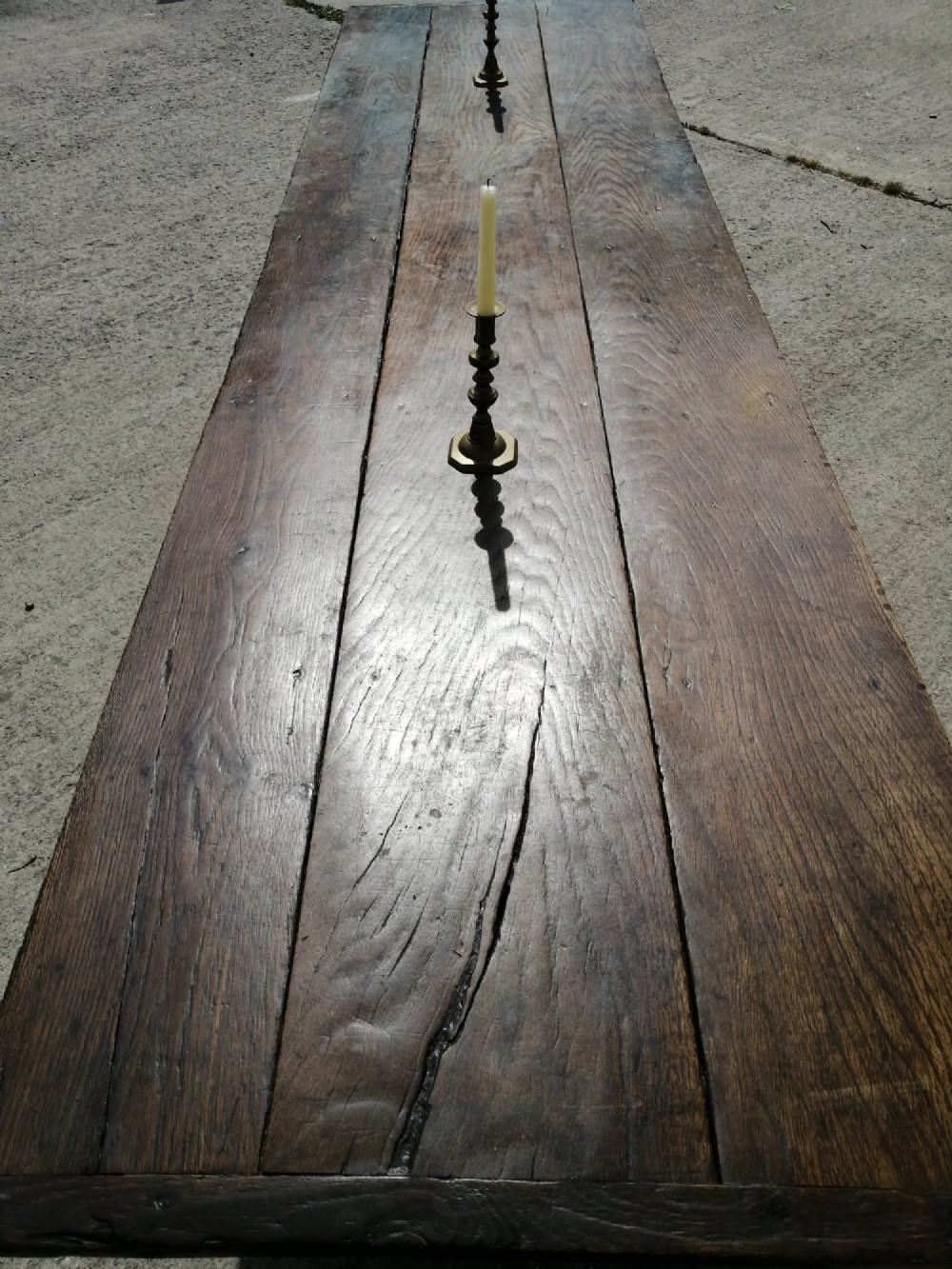 A long George I oak and elm refectory table featuring a plank top and low stretcher base. View III