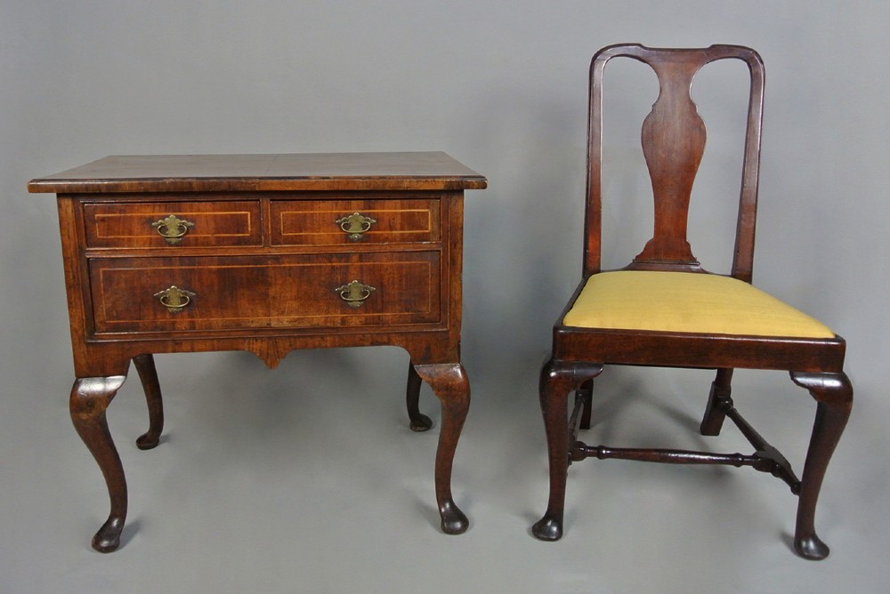A George I walnut lowboy table featuring three featherbanded drawers with brass handles, cabriole legs, pad feet, and a shaped apron. View II