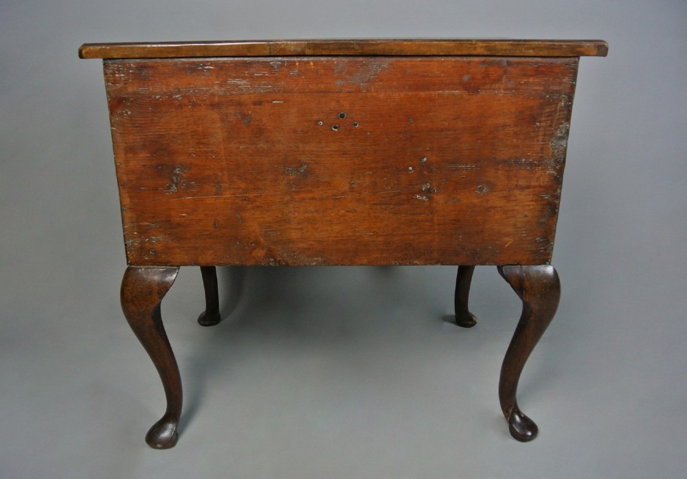 A George I walnut lowboy table featuring three featherbanded drawers with brass handles, cabriole legs, pad feet, and a shaped apron. View V