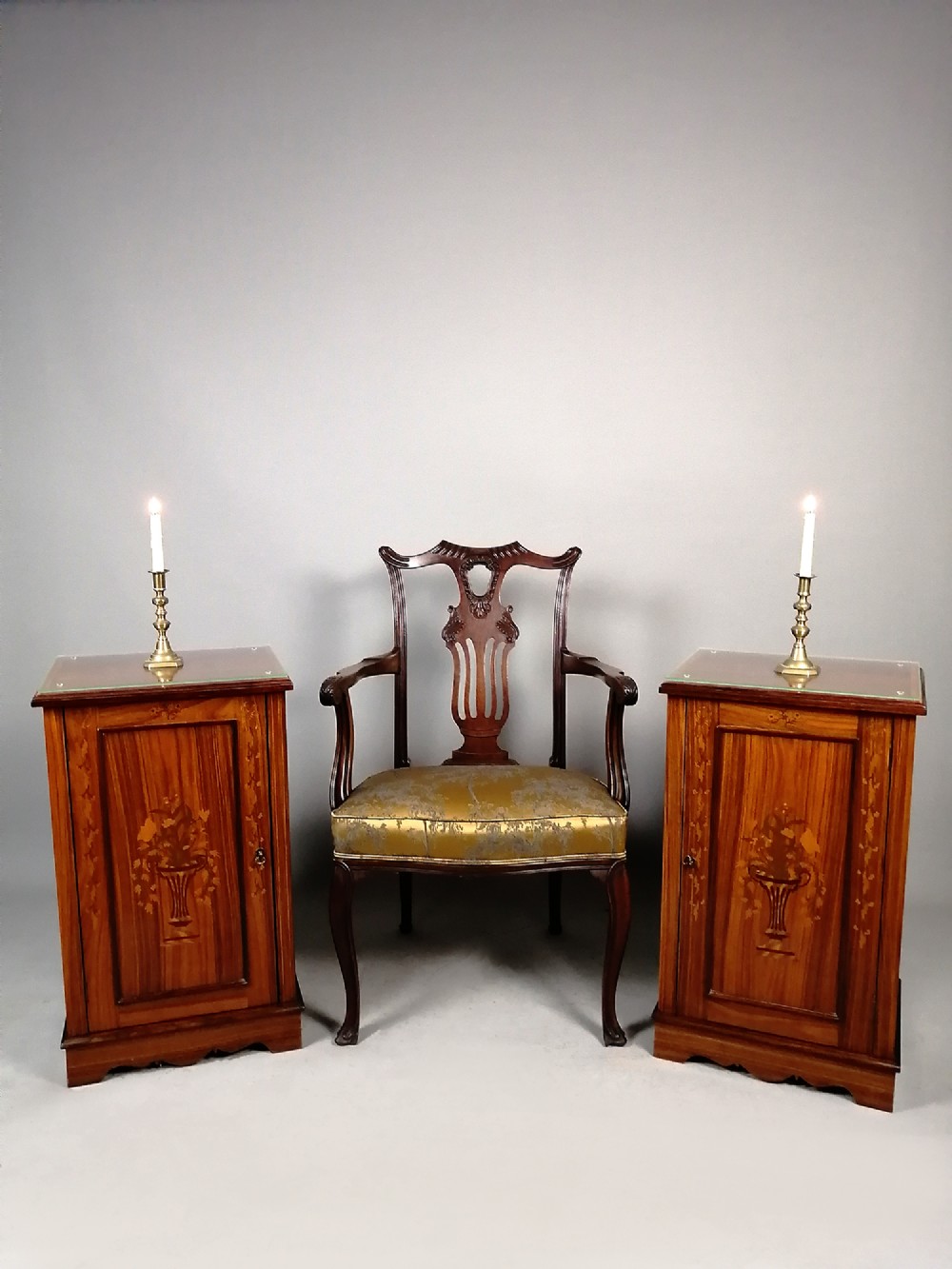 A pair of late Victorian rosewood bedside cupboards featuring central floral urn marquetry inlays on single-panel doors and plinth bases. View IX