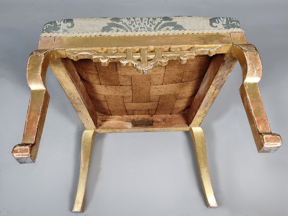 A 19th-century Chinese Chippendale style giltwood side chair featuring carved fretwork and damask upholstery. View X