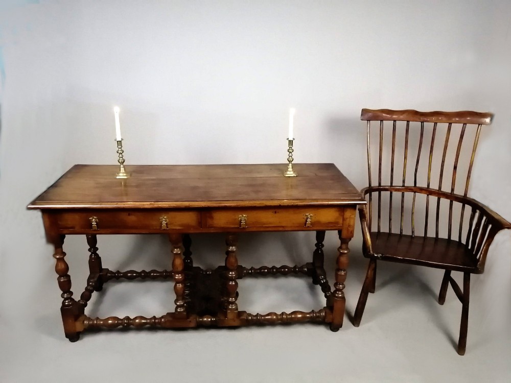 A Georgian walnut dresser sideboard featuring two frieze drawers with brass drop handles, turned legs, and low stretchers. View II