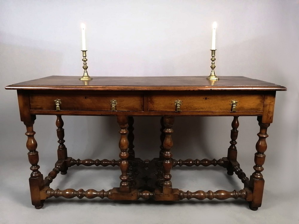 A Georgian walnut dresser sideboard featuring two frieze drawers with brass drop handles, turned legs, and low stretchers. View III