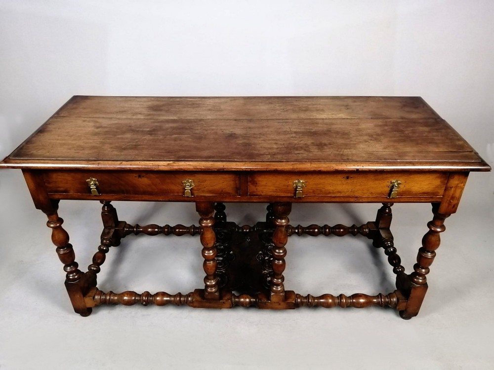 A Georgian walnut dresser sideboard featuring two frieze drawers with brass drop handles, turned legs, and low stretchers. View IV