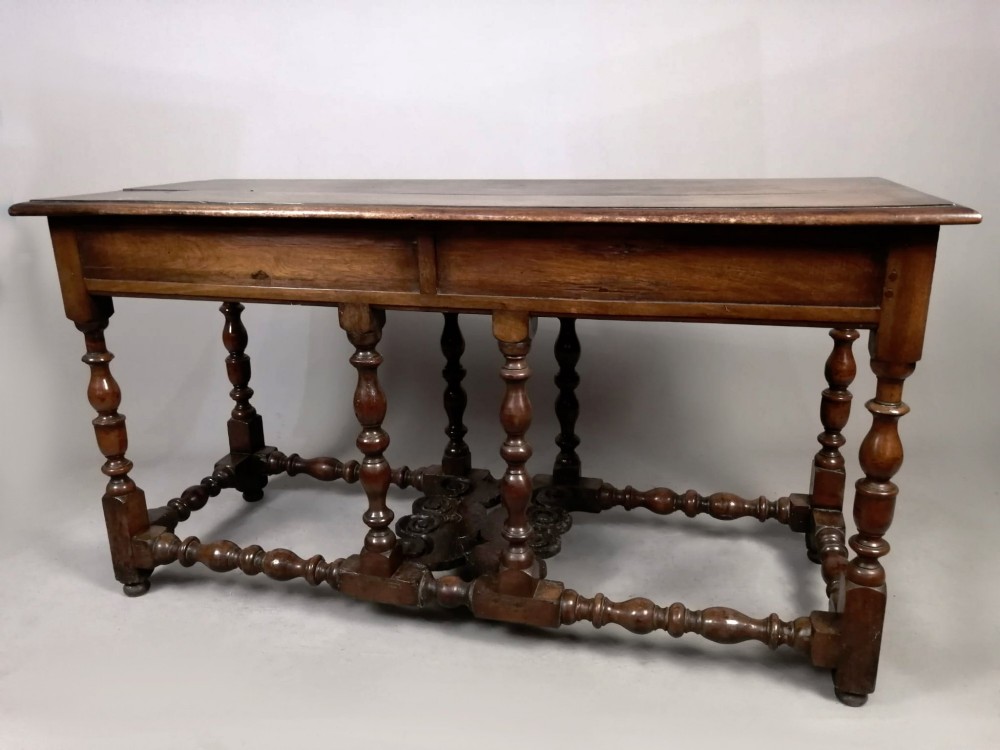 A Georgian walnut dresser sideboard featuring two frieze drawers with brass drop handles, turned legs, and low stretchers. View VII
