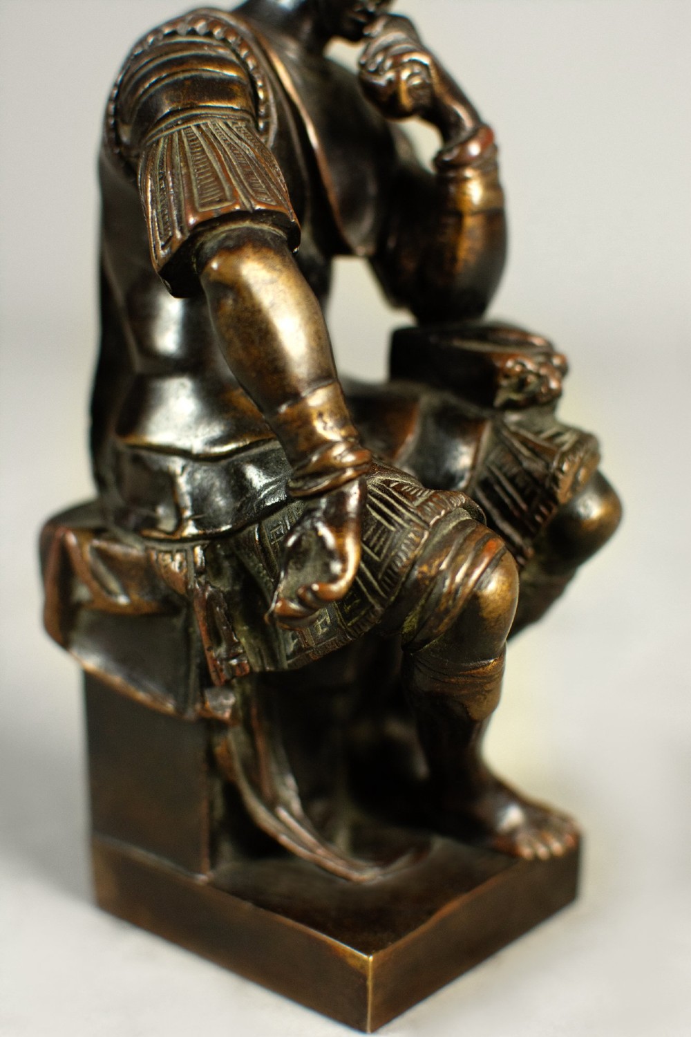 A dark patinated bronze figure depicting Lorenzo de Medici seated in a thoughtful pose on a rectangular base. View VI