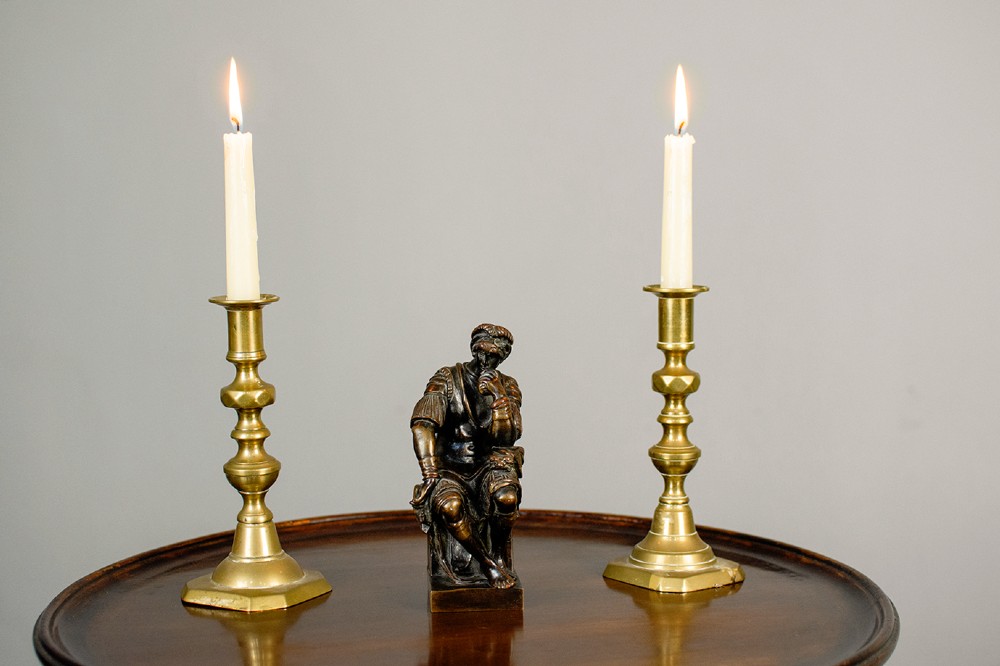 A dark patinated bronze figure depicting Lorenzo de Medici seated in a thoughtful pose on a rectangular base. View VIII