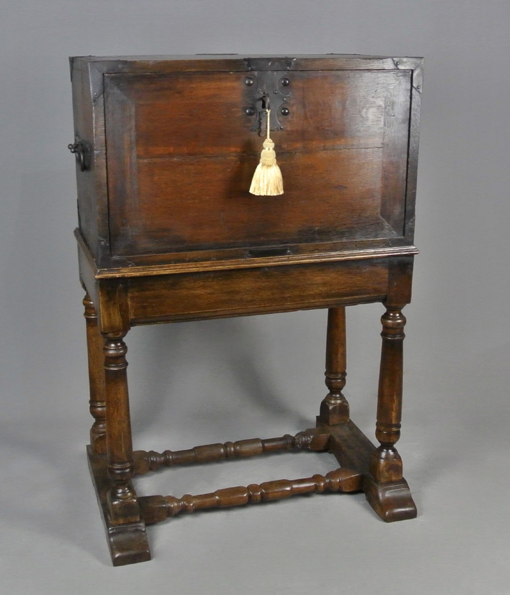 A seventeenth-century dark oak fall-front writing desk on a turned leg stand with interior drawers and wrought iron corner brackets. View III