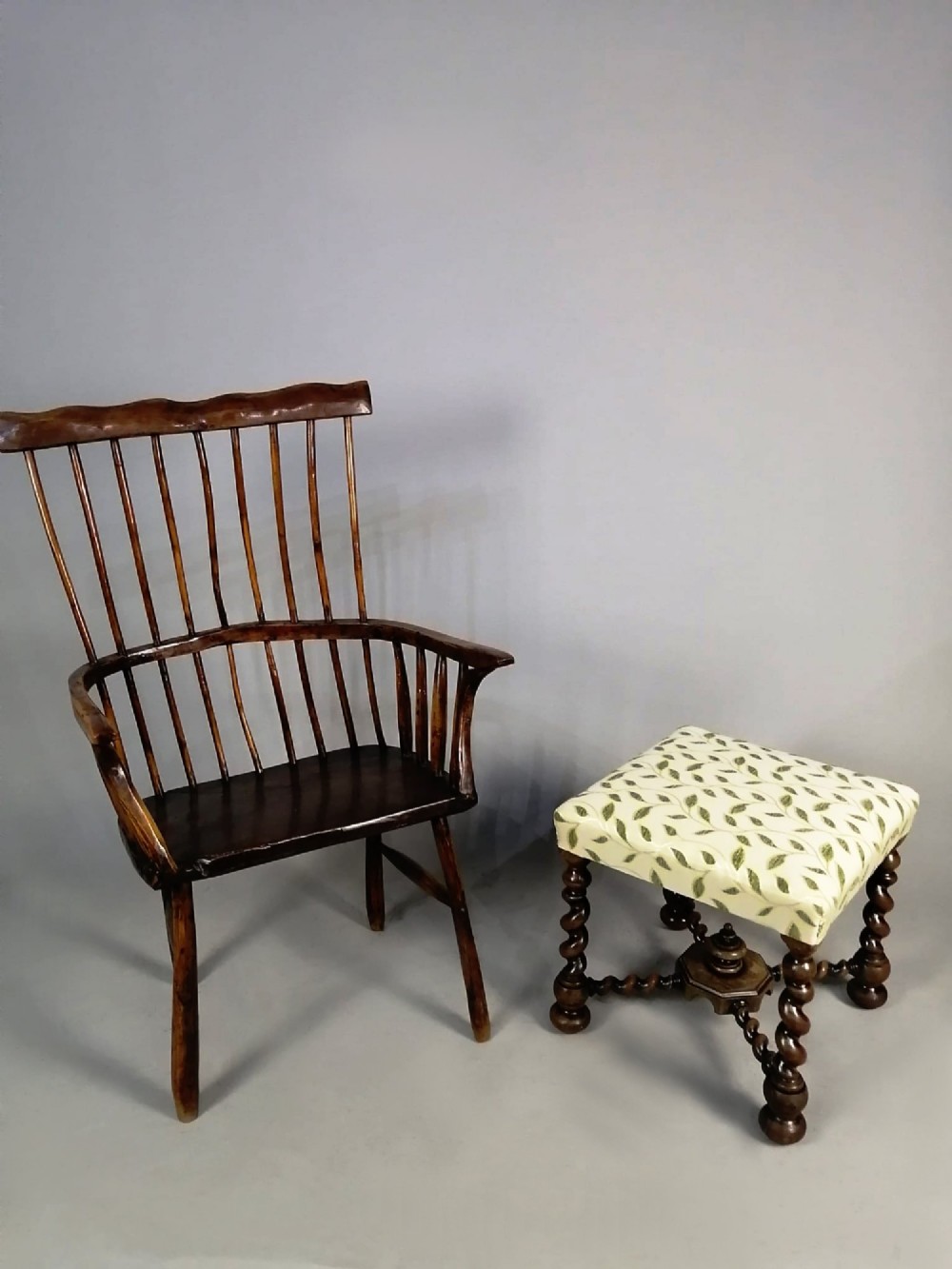 A square dark walnut stool featuring spiral barley twist legs, a central finial stretcher, and cream upholstery with embroidered green leaf motifs. View V