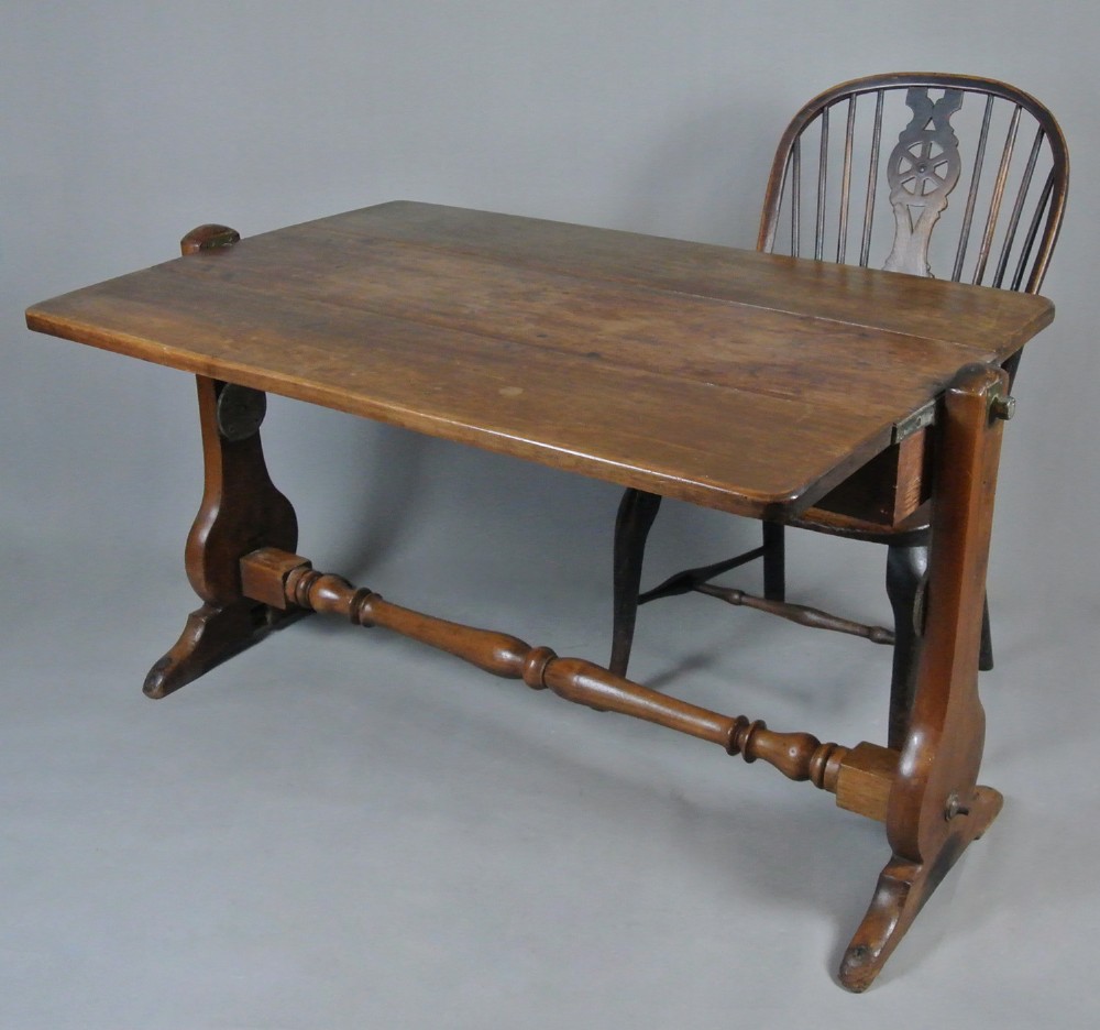 An 18th-century Georgian solid teak campaign table featuring a tilting rectangular top, a turned cross stretcher, and trestle end supports. View IV
