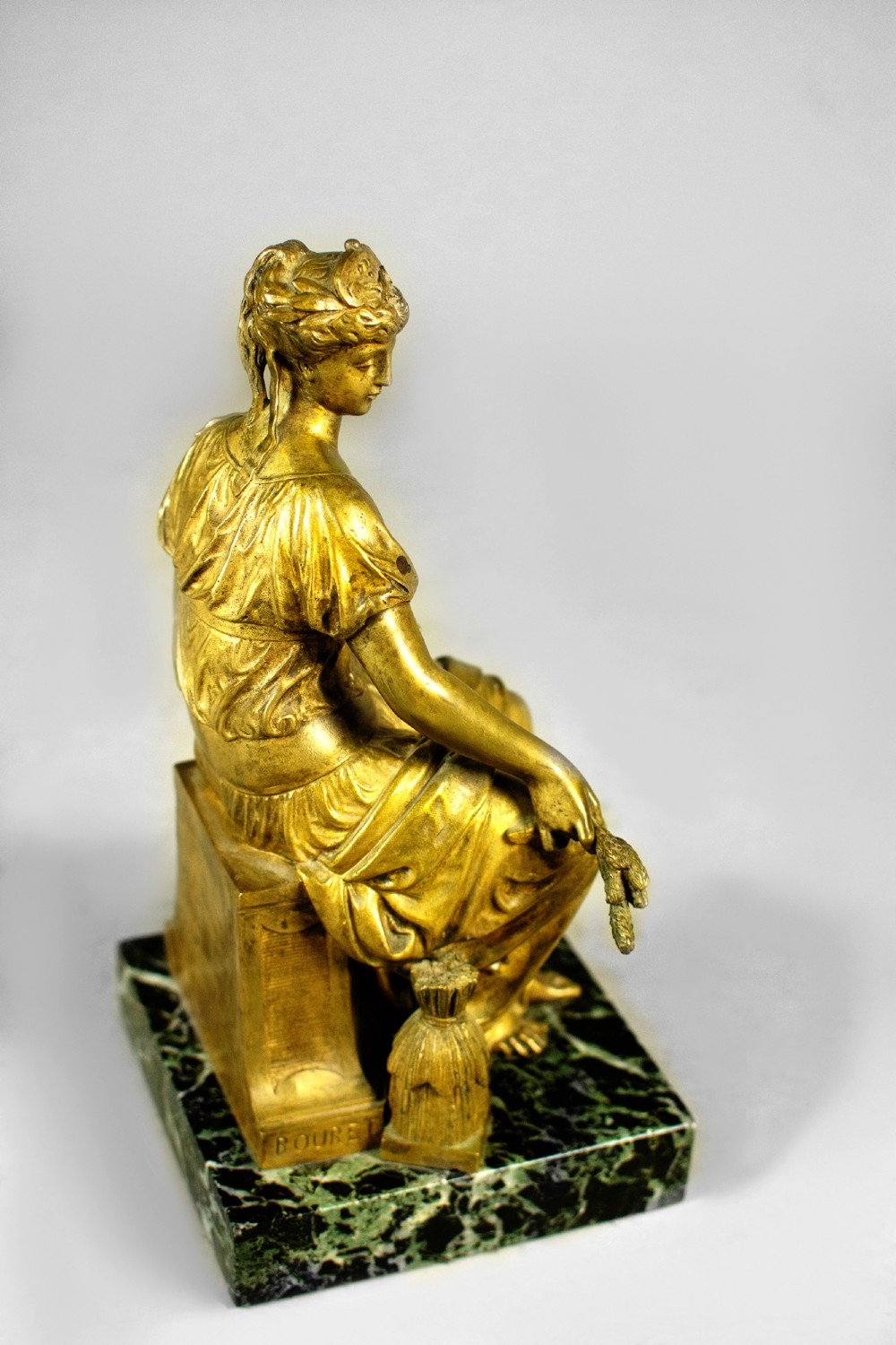 A nineteenth-century gilt bronze sculpture depicting the seated Roman goddess Ceres holding a sheaf of wheat on a square green marble base. View II