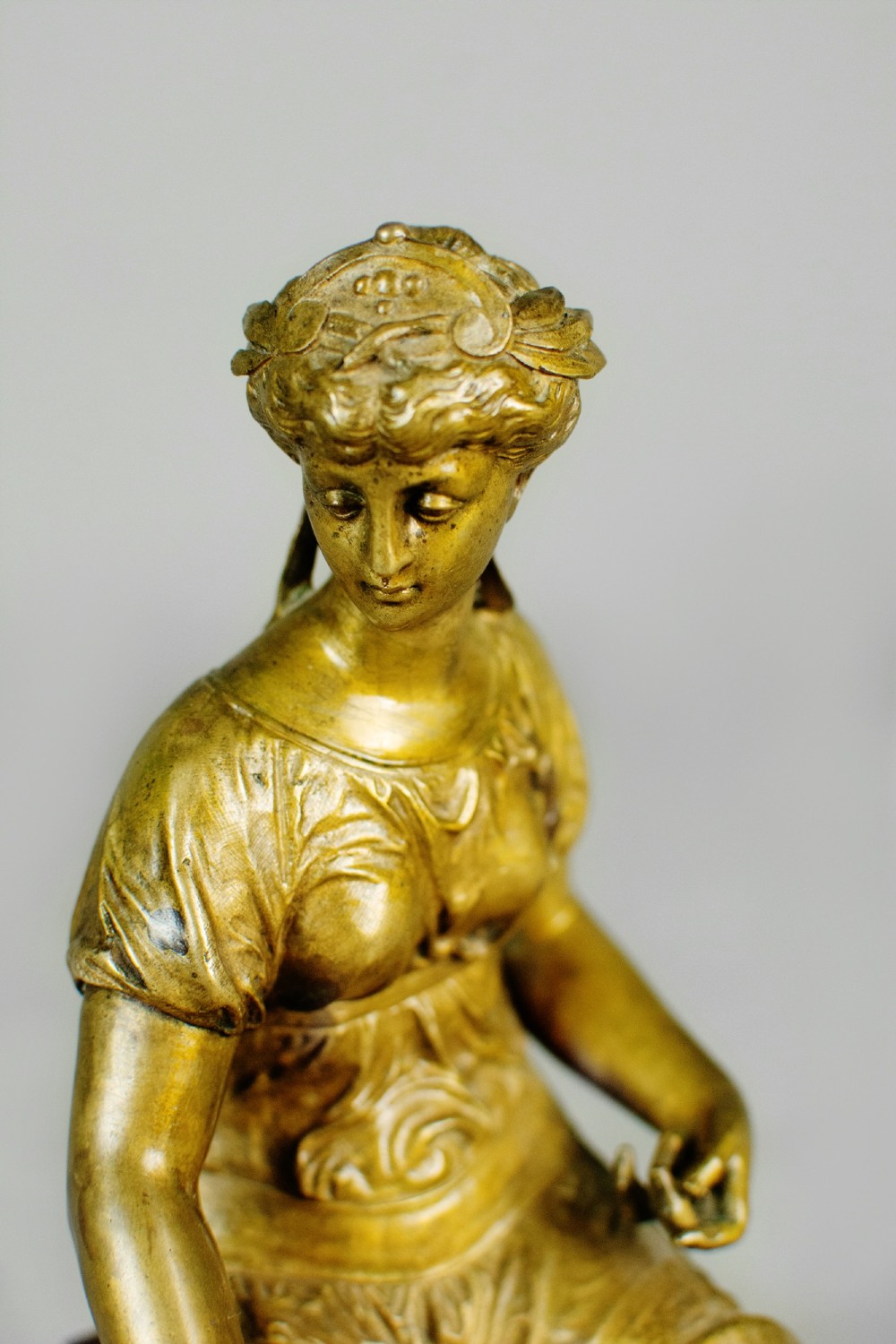 A nineteenth-century gilt bronze sculpture depicting the seated Roman goddess Ceres holding a sheaf of wheat on a square green marble base. View IX