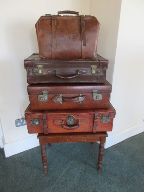 fig 2. Stack of three leather suit cases & a large size Gladstone bag, all the suitcases are c1900. 