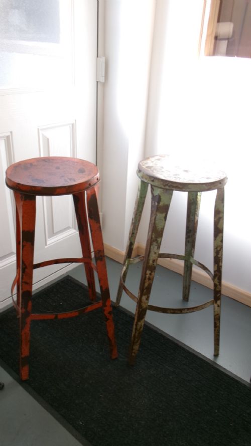 PAIR OF 1920'S INDUSTRIAL METAL RIVETED BAR STOOLS