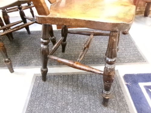 A set of four dark brown wooden fiddle back kitchen chairs featuring turned front legs and solid seats. View III
