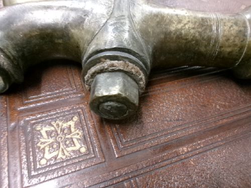 A heavy Victorian brass barrel tap featuring a tapered shaft, curved spout, T-bar handle, and an integrated locking loop mechanism. View IX