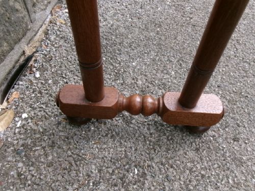 A freestanding Victorian mahogany towel rail featuring arched side supports, turned upright spindles, and four horizontal crossbars. View IV