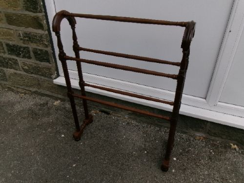 A freestanding Victorian mahogany towel rail featuring arched side supports, turned upright spindles, and four horizontal crossbars. View V