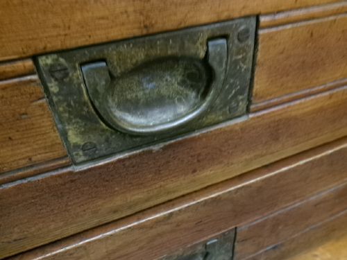 A pine military campaign chest featuring flush recessed brass handles and multiple small drawers. View II