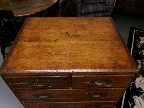 A pine military campaign chest featuring flush recessed brass handles and multiple small drawers. View III