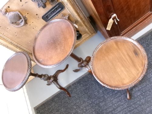 A trio of Edwardian mahogany wine tables featuring turned central pedestals, dished circular tops, and carved tripod cabriole legs. View VIII