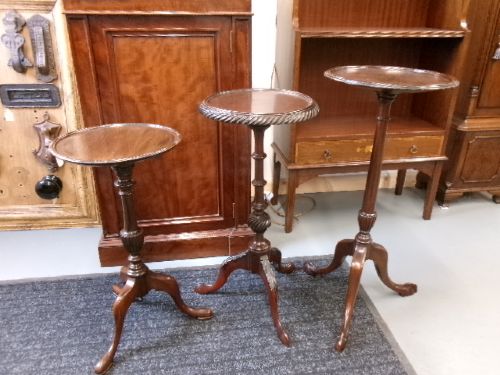 A trio of Edwardian mahogany wine tables featuring turned central pedestals, dished circular tops, and carved tripod cabriole legs. View XI