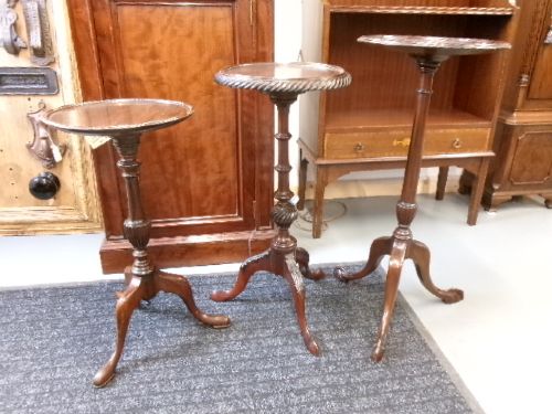 A trio of Edwardian mahogany wine tables featuring turned central pedestals, dished circular tops, and carved tripod cabriole legs. View XII