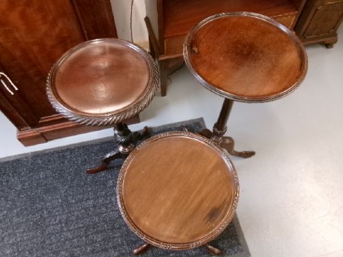 A trio of Edwardian mahogany wine tables featuring turned central pedestals, dished circular tops, and carved tripod cabriole legs. View XIII