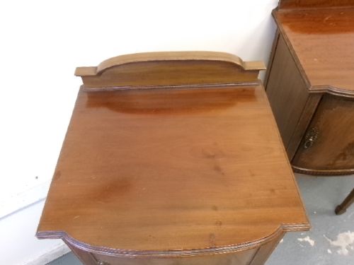 A pair of Edwardian mahogany bedside cabinets featuring bow fronts, satinwood string inlay, shaped upstands, and tapered legs. View VI