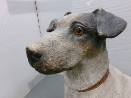 A Victorian painted terracotta figure depicting a seated Jack Russell terrier with grey ears and a brown painted collar. View III