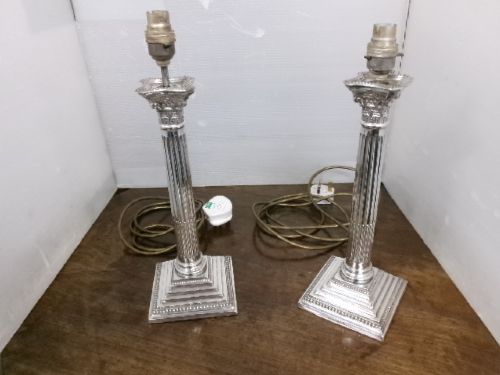 A pair of silver-plated table lamps designed as fluted Corinthian columns set upon square stepped bases. View II