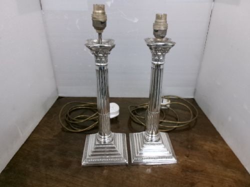 A pair of silver-plated table lamps designed as fluted Corinthian columns set upon square stepped bases. View III