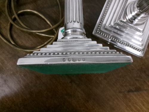 A pair of silver-plated table lamps designed as fluted Corinthian columns set upon square stepped bases. View VI