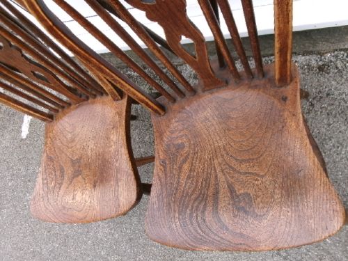 A pair of traditional wooden Windsor chairs featuring contoured elm seats, pierced wheelback splats, hoop backs, and turned legs connected by H-stretchers. View VIII