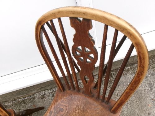 A pair of traditional wooden Windsor chairs featuring contoured elm seats, pierced wheelback splats, hoop backs, and turned legs connected by H-stretchers. View XI