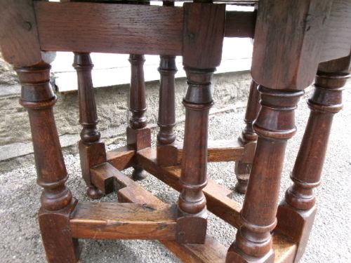 A compact Georgian oak and elm gateleg table with two drop leaves, turned legs, and lower stretchers. View III