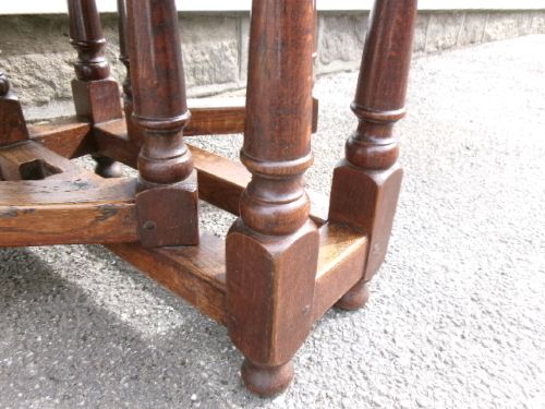 A compact Georgian oak and elm gateleg table with two drop leaves, turned legs, and lower stretchers. View IV