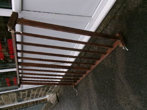 A rectangular 19th-century pine oatcake drying rack featuring slatted timber bars and hanging rope loops. View VII