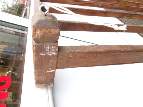A rectangular 19th-century pine oatcake drying rack featuring slatted timber bars and hanging rope loops. View IX